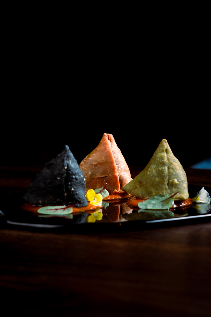 Tricolor of Samosa on a black plate at Queen’s Tandoor Indian Restaurant Bali