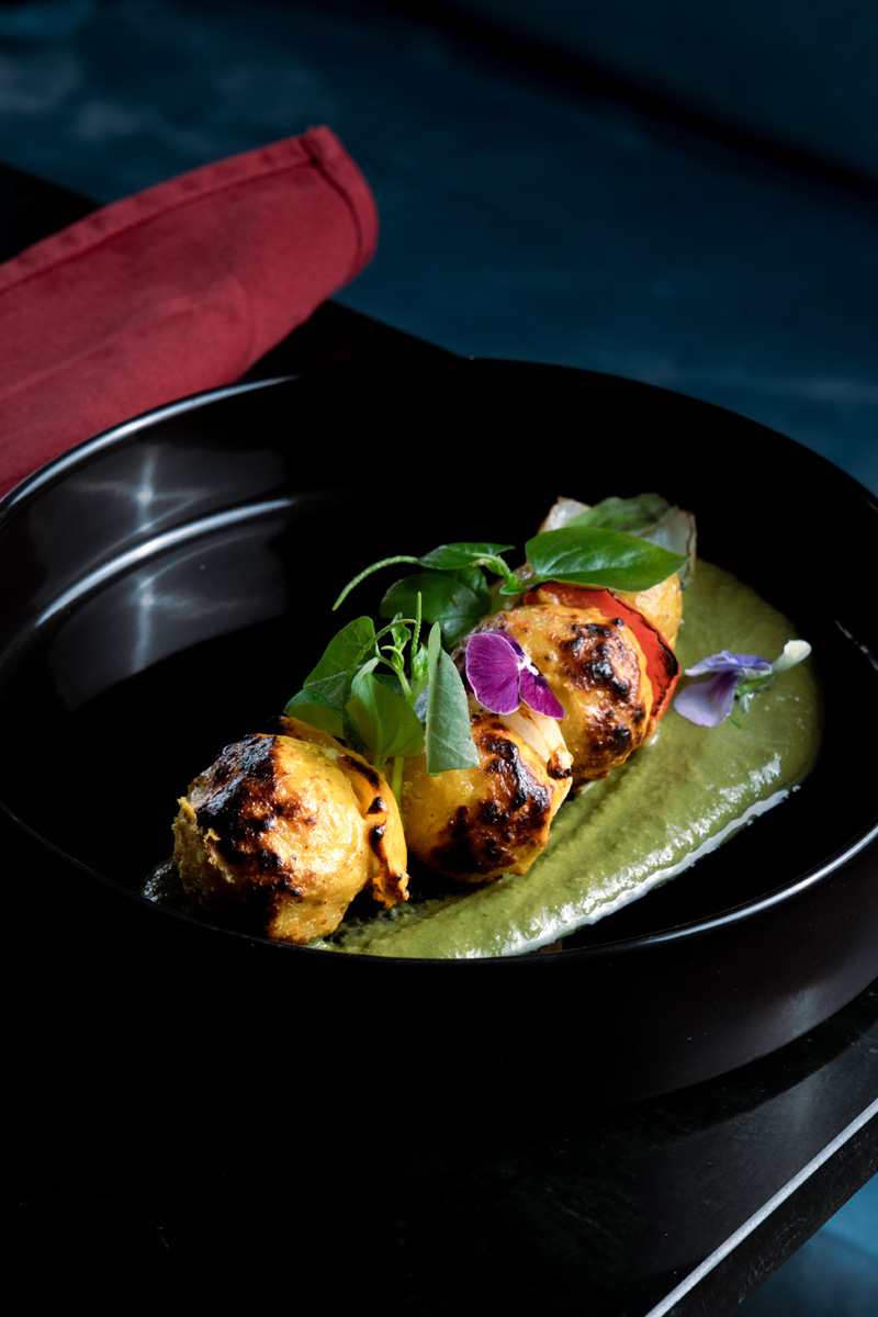 Aloo Tika in a black plate at Queen’s Tandoor Indian Restaurant Bali
