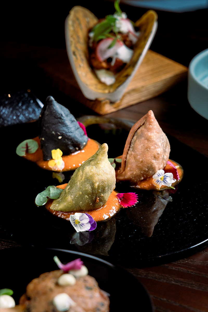 Trio of Samosa on a black plate at Queen’s Tandoor Indian Restaurant Seminyak Bali