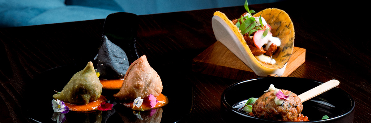 Three colorful samosa, taco tepla and kebab pop on a table at Queen’s Tandoor Indian Restaurant Seminyak Bali